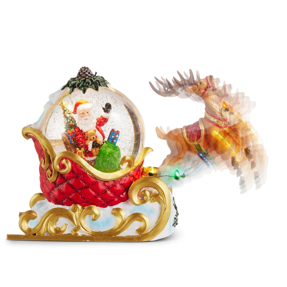 Front view of a red and gold resin animated Santa sleigh lighted water globe with a motion-blurred reindeer.