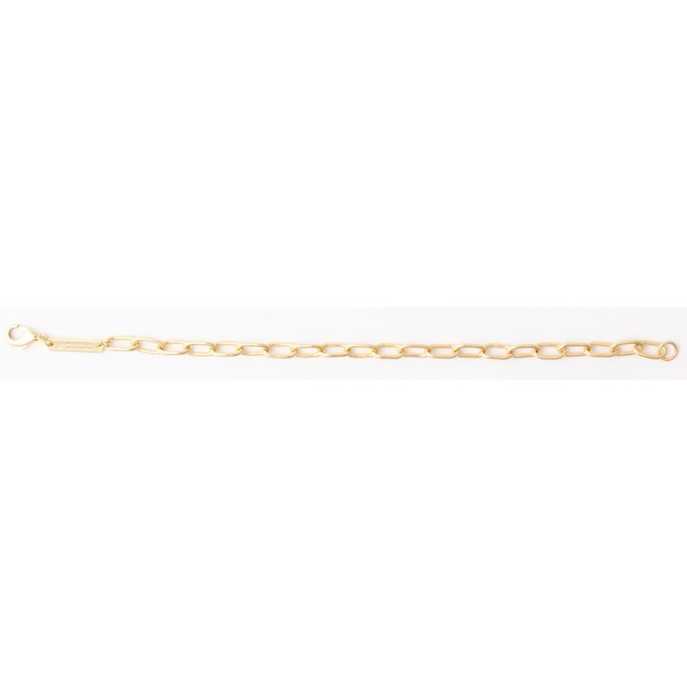 Gold oval link chain bracelet with a lobster clasp and rectangular metal logo tag.