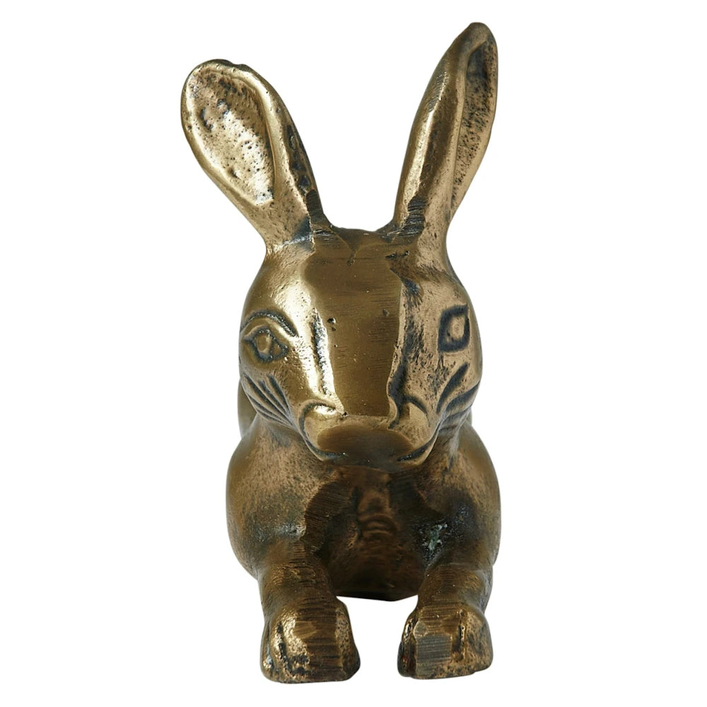 Antique brass finish cast aluminum rabbit figurine sitting forward on a white background.