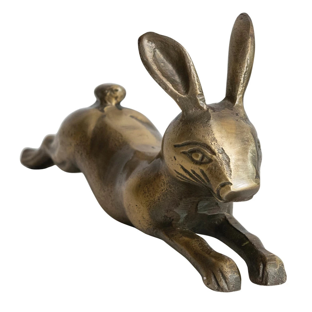 A detailed, mid-century bronze hare sculpture in a full-length leaping pose with a rich, patinated finish.