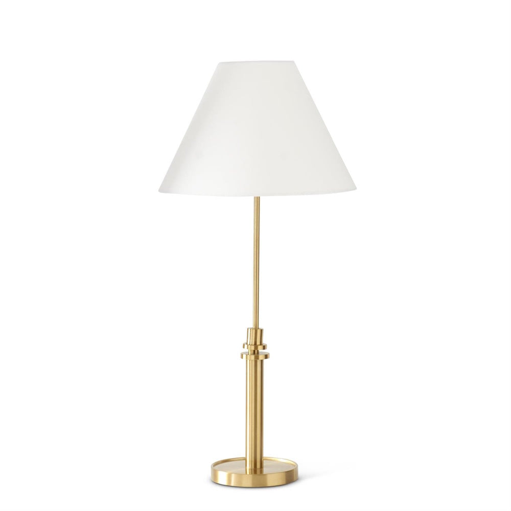 Modern brass table lamp with a slim gold stem and a tapered white fabric shade for elegant home lighting.