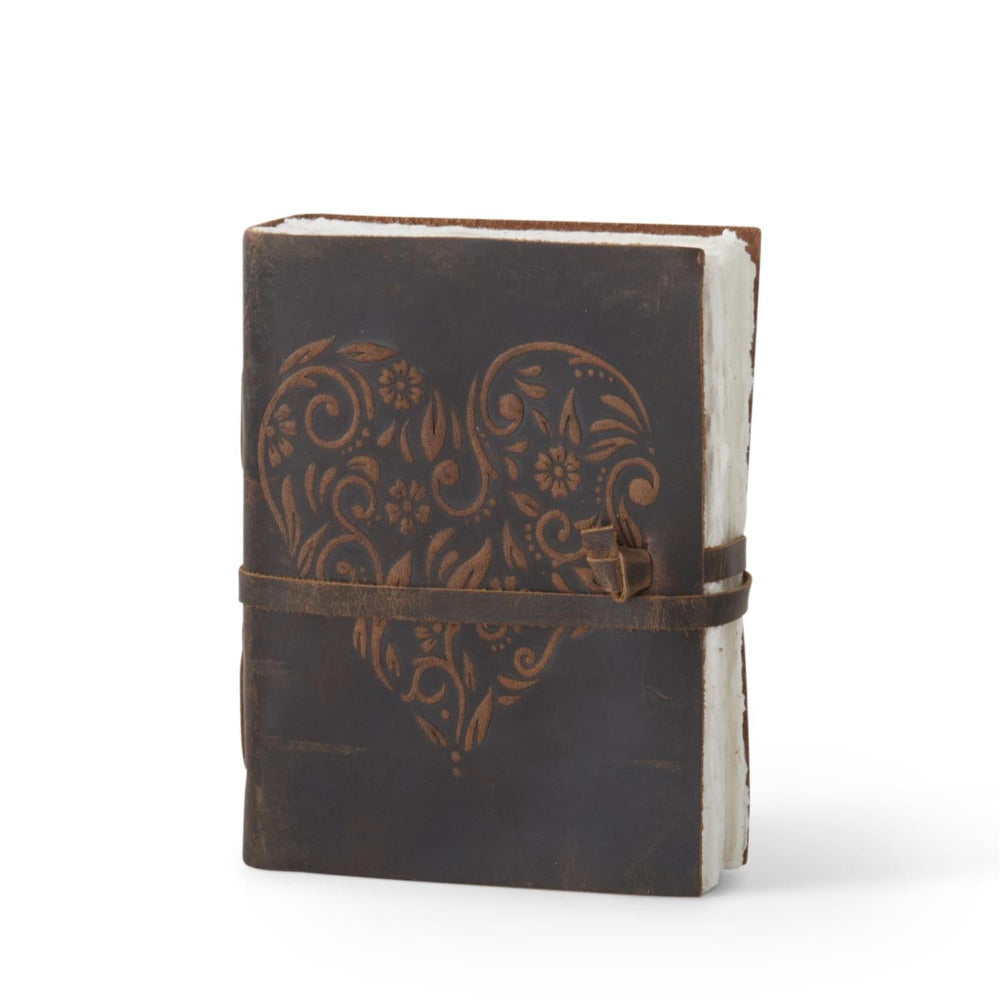 Handcrafted antique brown leather journal featuring an embossed floral heart and rustic deckle-edge paper.