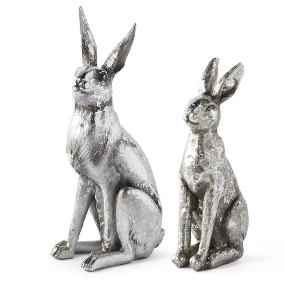 Two metallic silver rabbit figurines with a distressed, rustic finish sitting side-by-side on a white background.