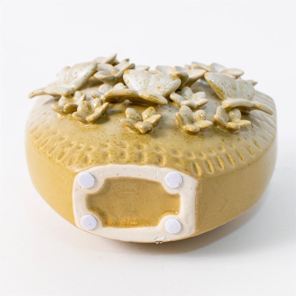 Yellow ceramic vase with 3D applied butterfly and flower designs, textured finish, and felt floor protectors on base.