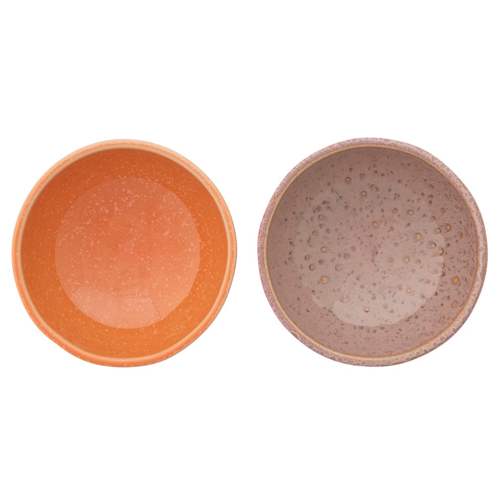 Top view of two speckled stoneware bowls, one apricot orange and one berry purple.