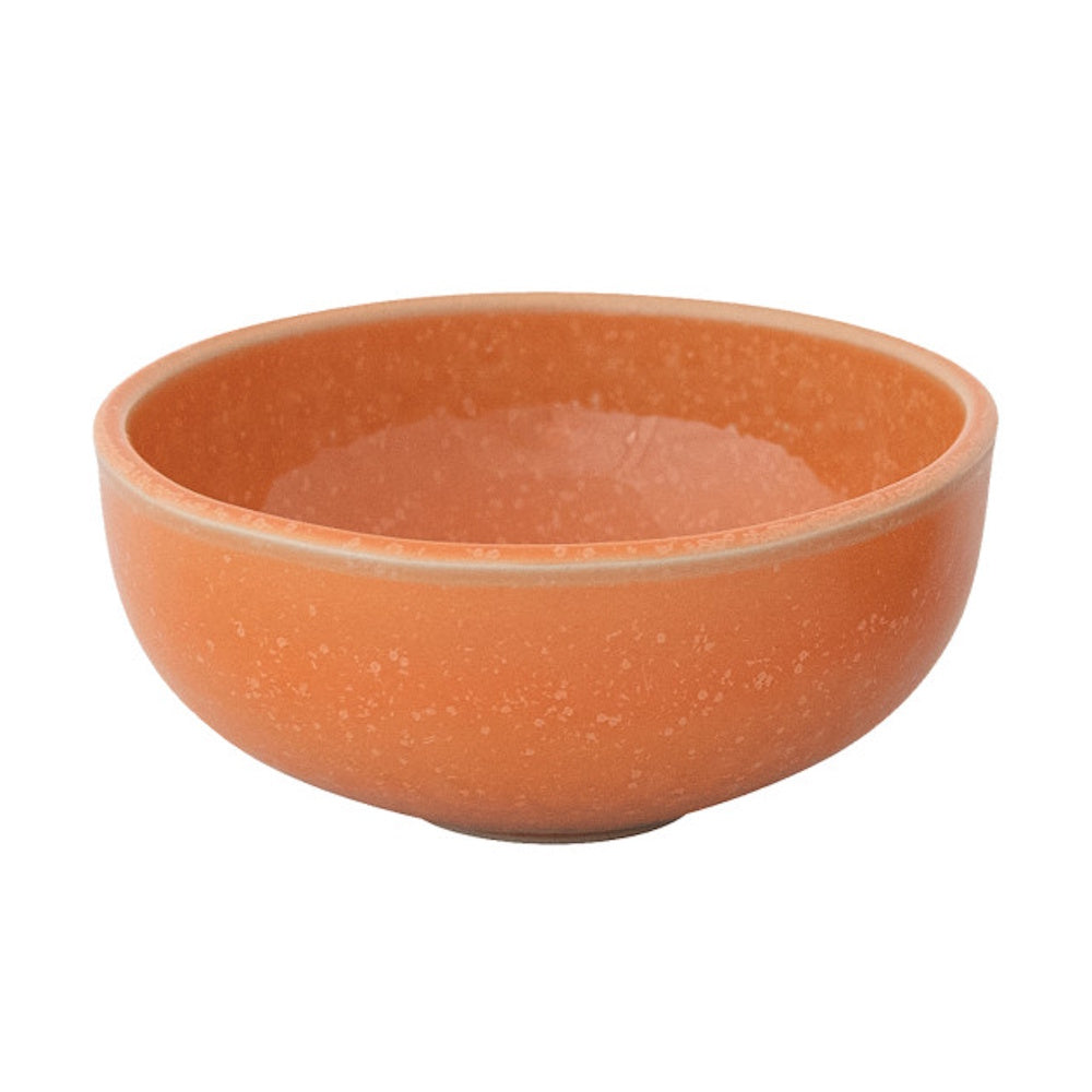 A round, speckled apricot orange stoneware bowl on a white background.