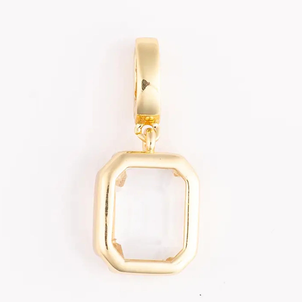 Gold charm featuring a clear, rectangular emerald-cut gemstone set in a polished gold bezel frame.