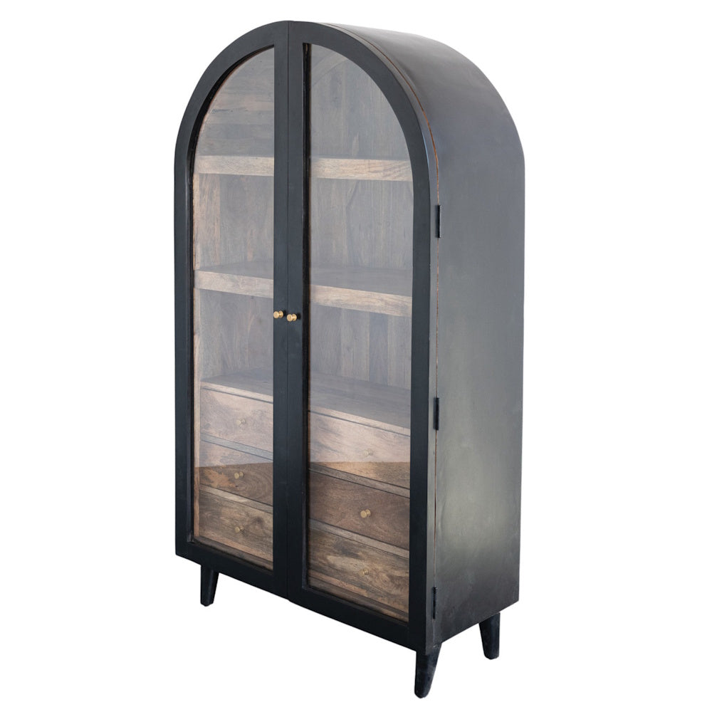 Black arched mango wood cabinet with two glass doors, interior shelves, and three wooden drawers on a white background.