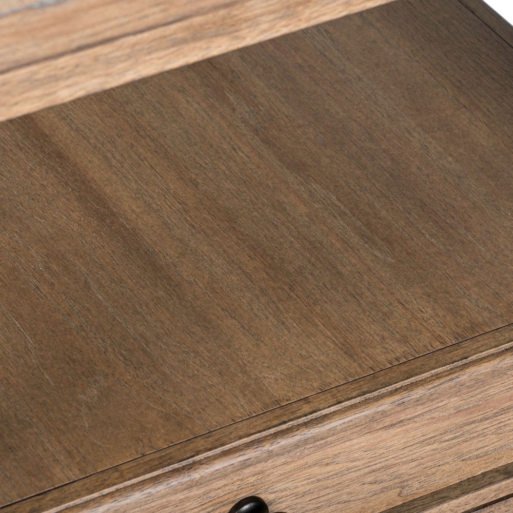 Close-up of the open shelf and smooth wood grain surface on a light-brown wooden end table.
