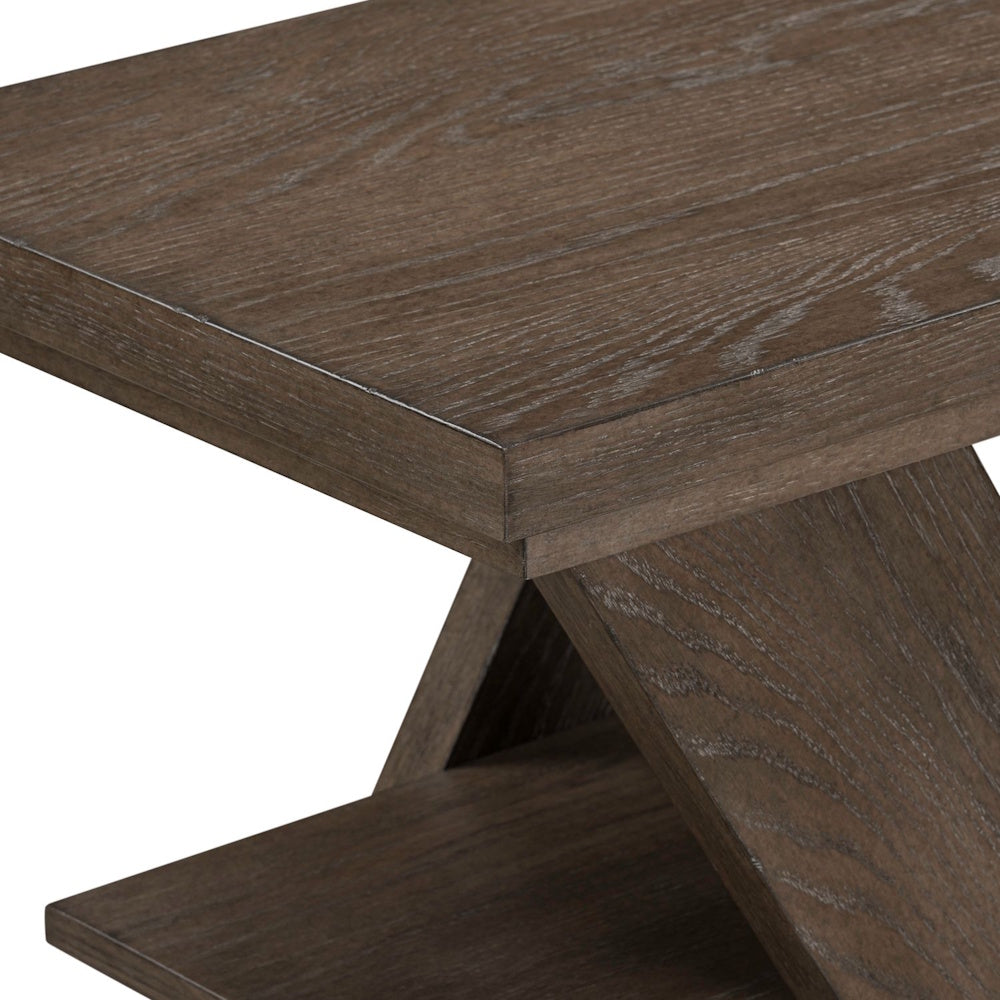 Close-up of a rustic brown wood chairside table featuring a textured oak finish and a modern Z-shaped base design.