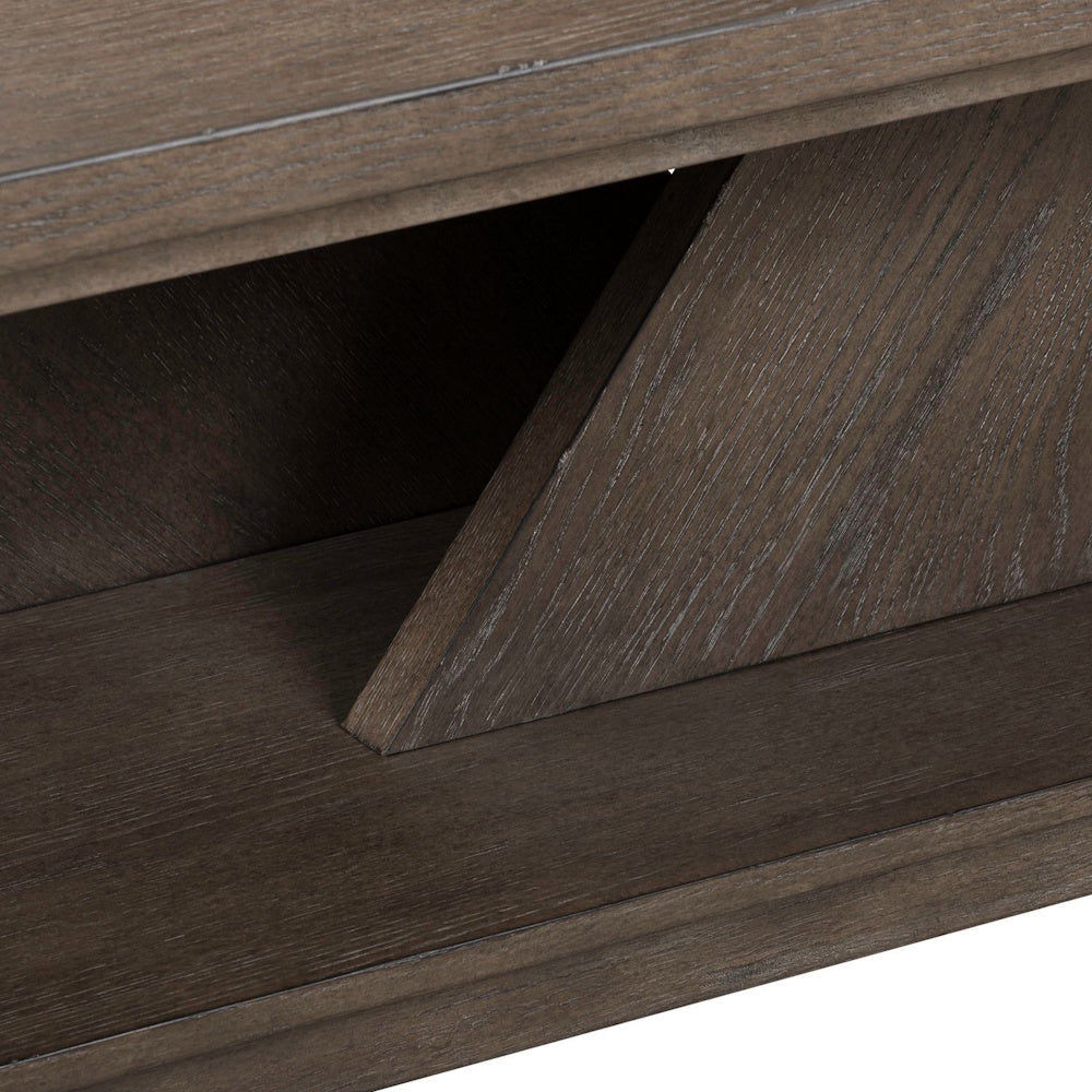 Close-up of an Aspen Sky cocktail table base showing the weathered dark gray wood grain and angular support beam.