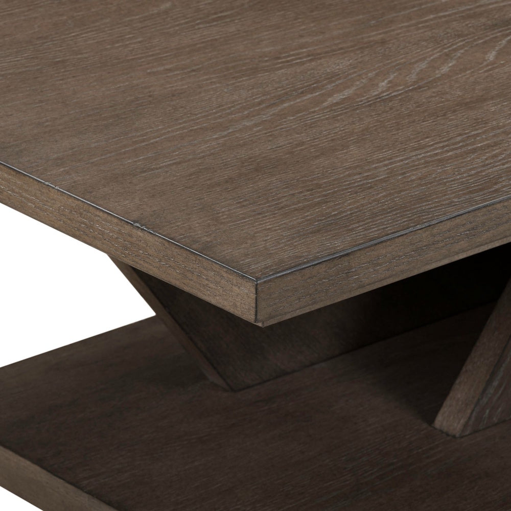 Close-up of the Aspen Sky cocktail table featuring a weathered dark brown wood finish and modern trestle base.