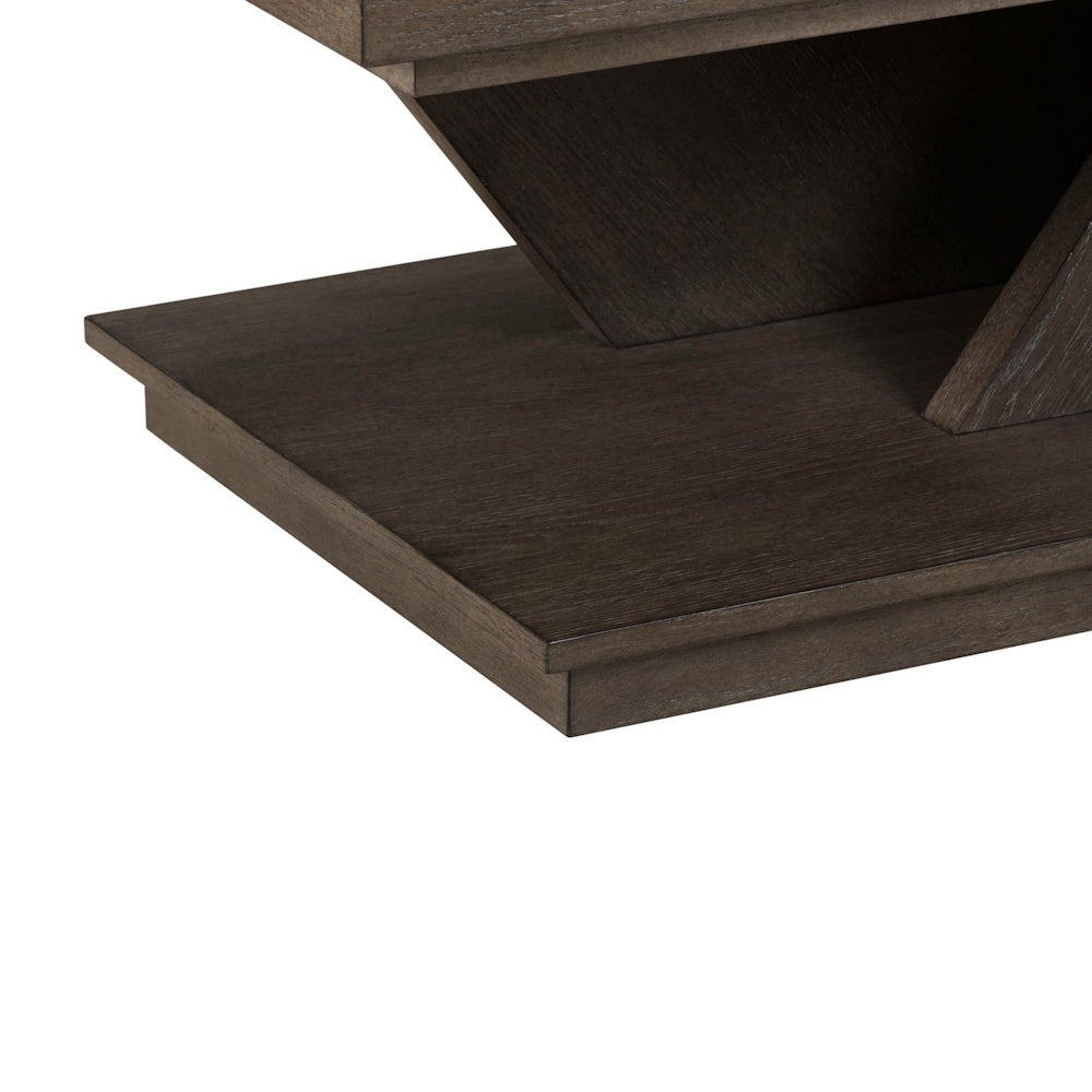 Close-up of the Aspen Sky cocktail table's dark charcoal wood base, highlighting the geometric design and wood grain.