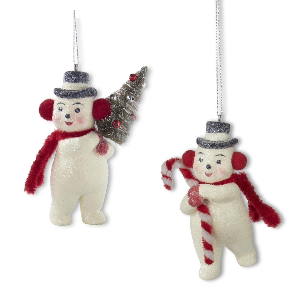 Two glittered snowman ornaments wearing earmuffs, scarves, and top hats, with one holding a bottle brush tree and the other a candy cane.