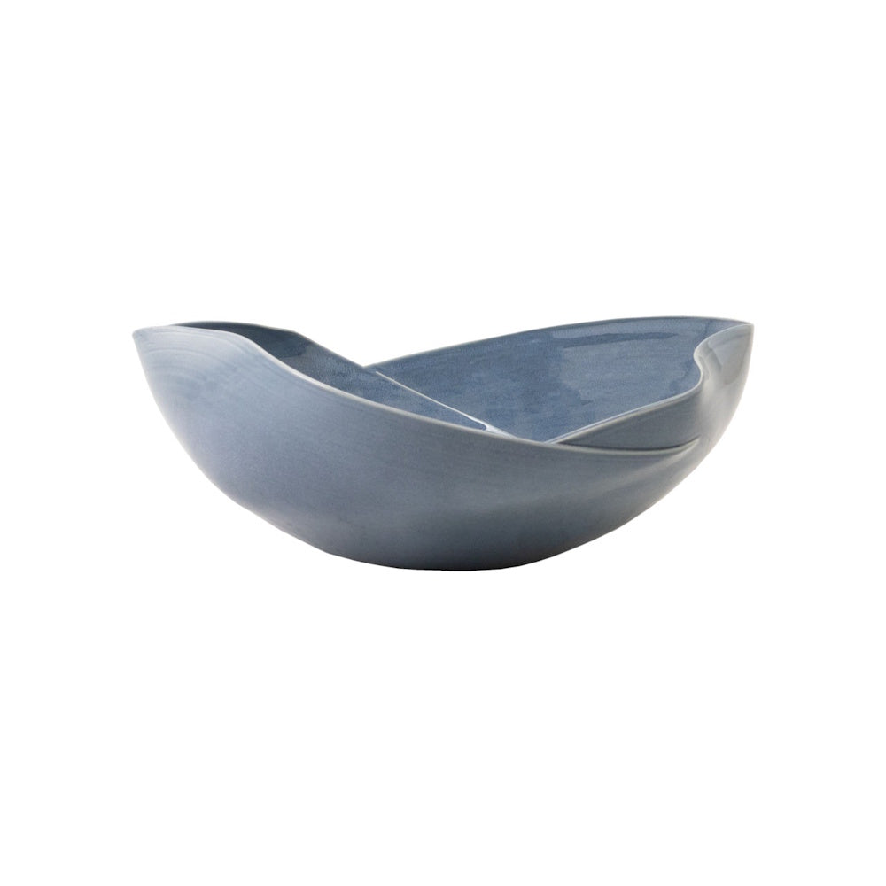 Modern wavy blue ceramic decorative bowl with a reactive glaze and organic silhouette for home decor.