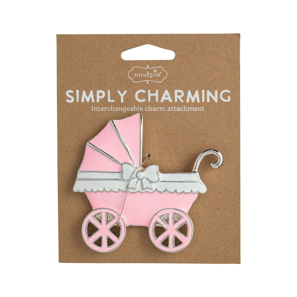 Pink baby stroller charm attachment by Mud Pie on cardboard packaging.