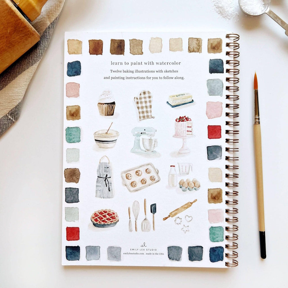 Watercolor baking workbook back cover with tiny illustrations, color swatches, and a paintbrush on a white table.