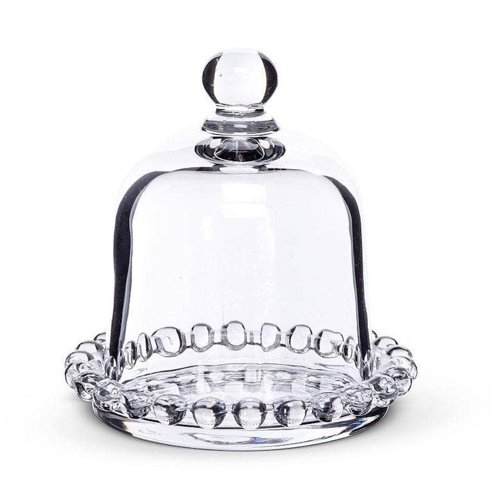 Clear glass cloche dome with round knob lid on a matching beaded rim accent plate.