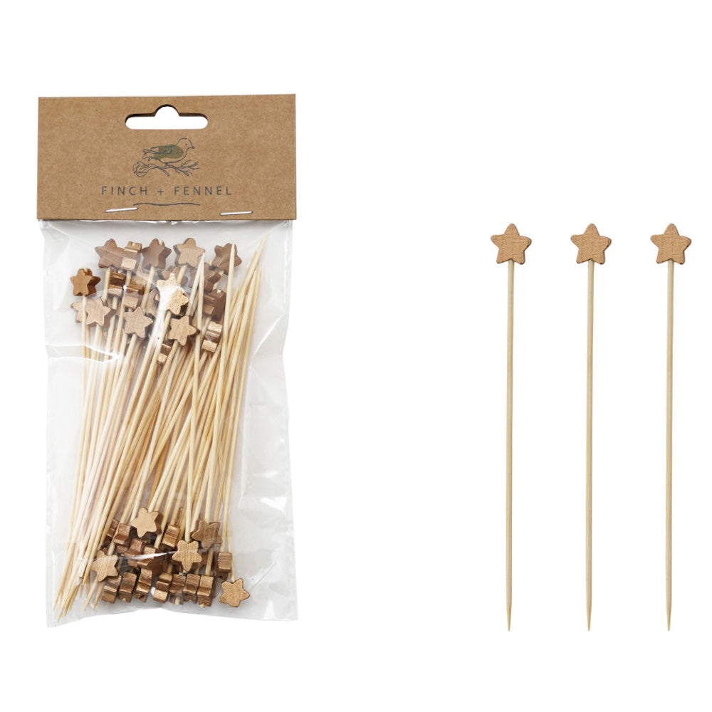 Packaged bamboo skewers topped with wooden star toppers alongside three loose star skewers.