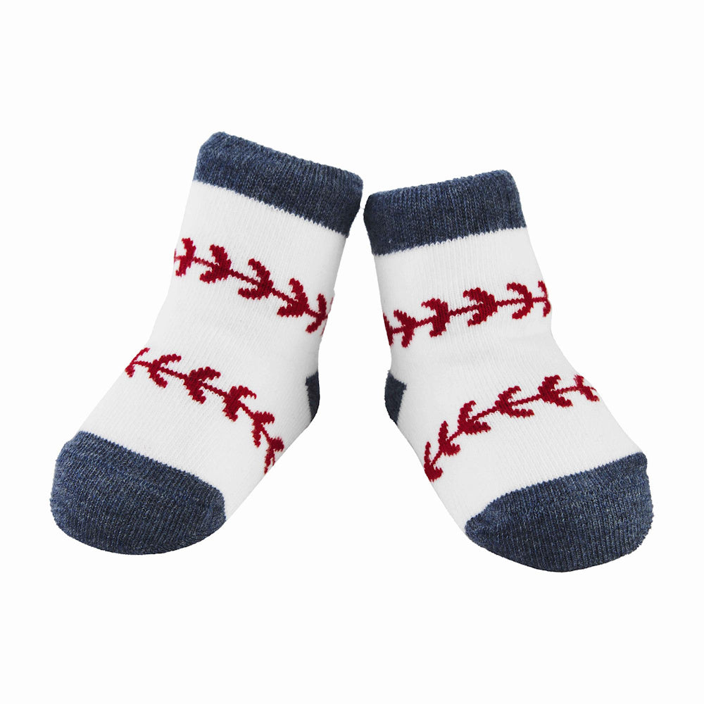 Pair of white baby socks with blue trim and red baseball stitching details on white background.