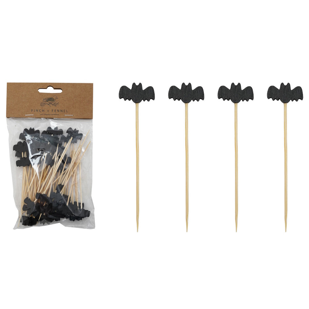 Packaged wooden appetizer picks topped with black bat cutouts next to four individual picks.