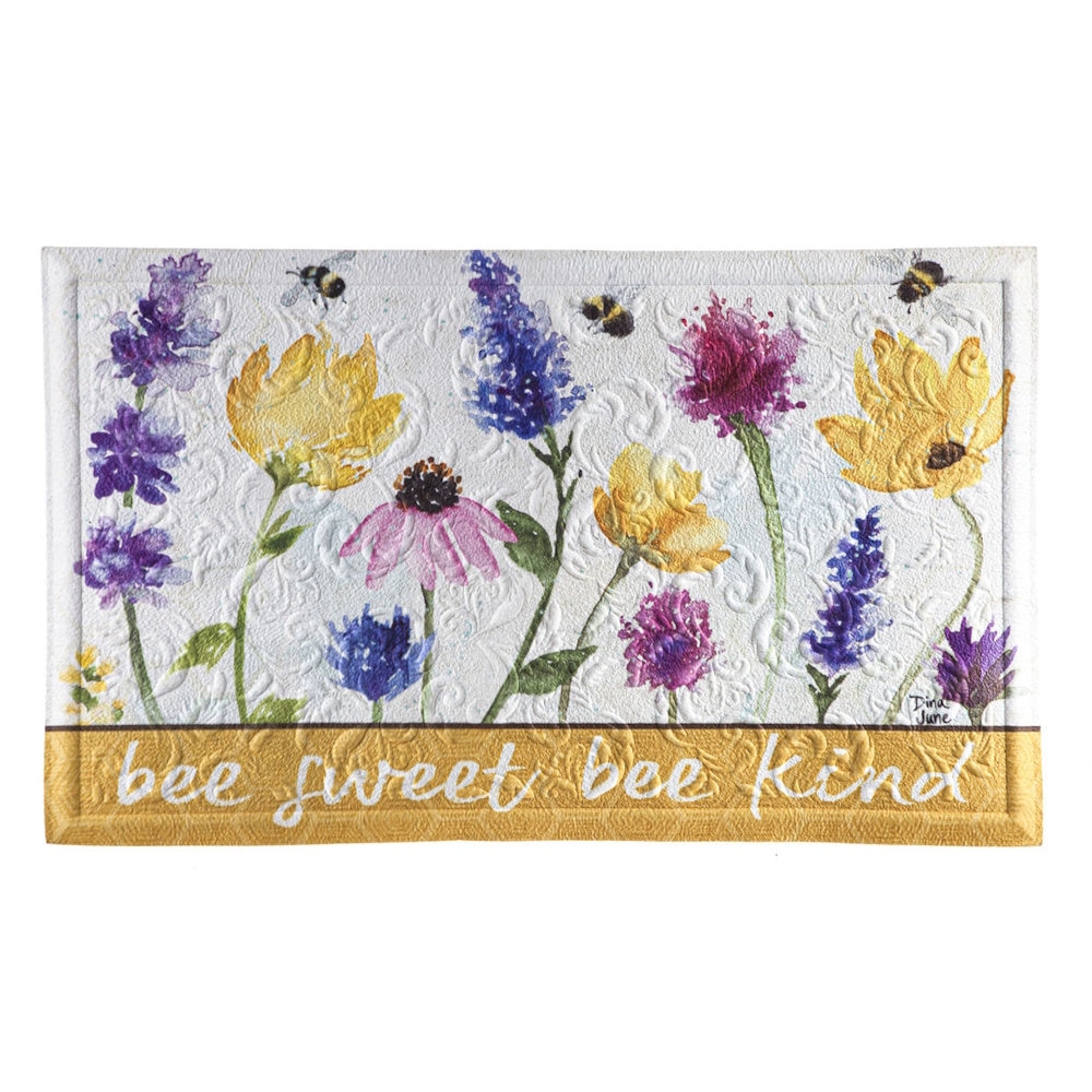 Embossed floor mat with painted wildflowers, bumblebees, and the cursive text "bee sweet bee kind."