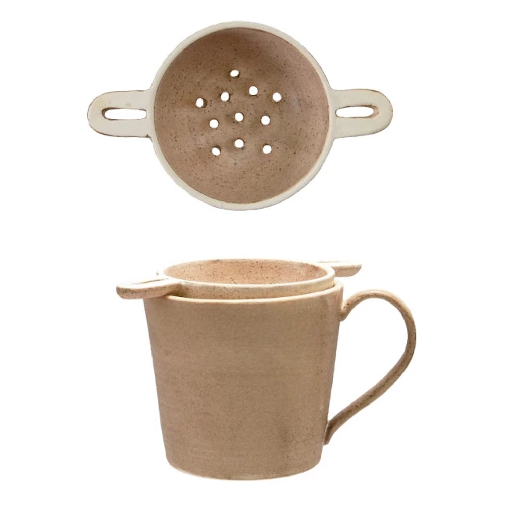 Beige stoneware tea mug with matching ceramic strainer and top view of infuser holes.