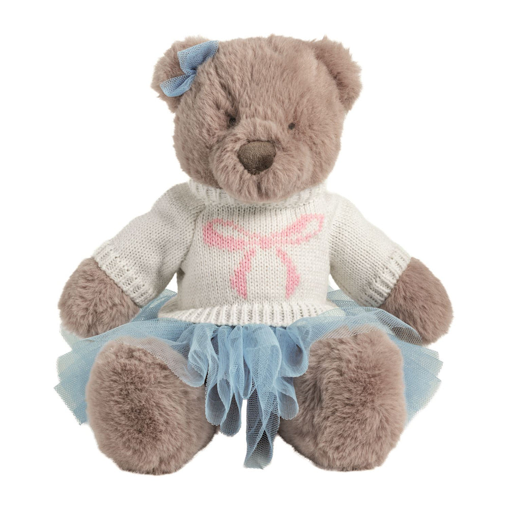 Plush brown teddy bear wearing a white knit sweater with a pink bow and a blue tulle tutu skirt.