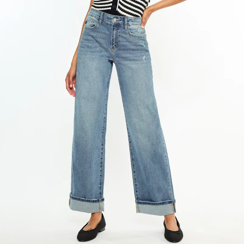 Woman wearing Bellen Essentials high-rise wide-leg jeans in light wash denim with cuffed hems and black ballet flats.