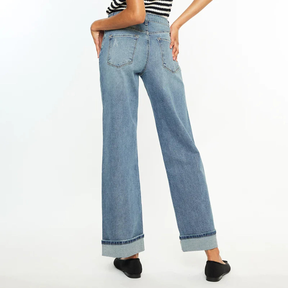 Back view of high-rise wide-leg jeans in medium wash denim with large folded cuffs and classic back pockets.