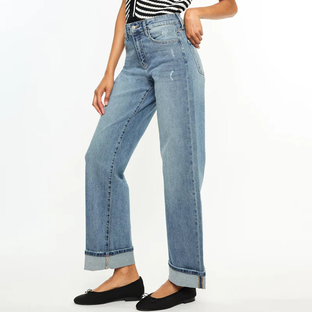 Woman wearing Bellen Essentials high-rise wide-leg jeans in light wash denim with cuffed hems and black ballet flats.