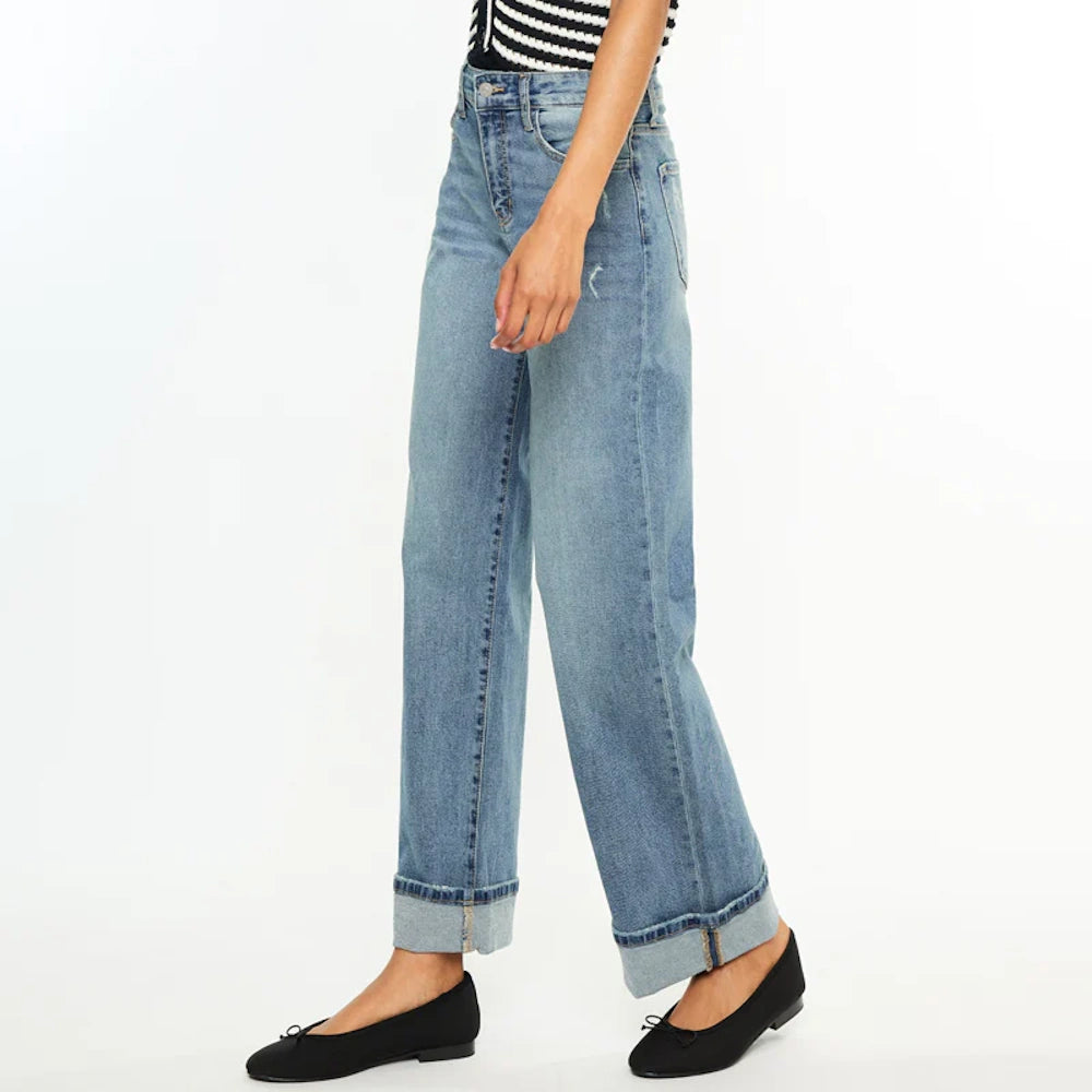 Side view of Bellen Essentials high-rise wide-leg jeans in light wash denim with wide cuffed hems.