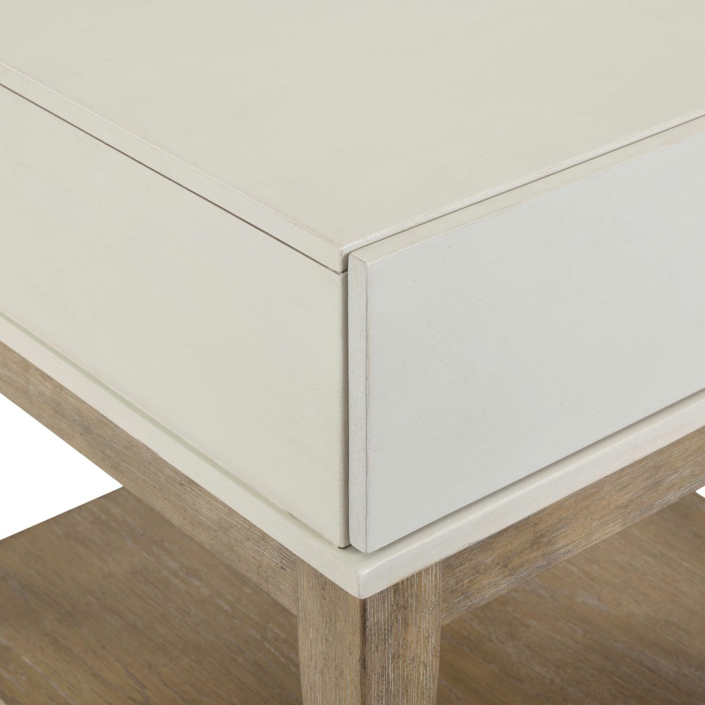 Close-up of painted drawer corner and wood frame on two-tone end table.