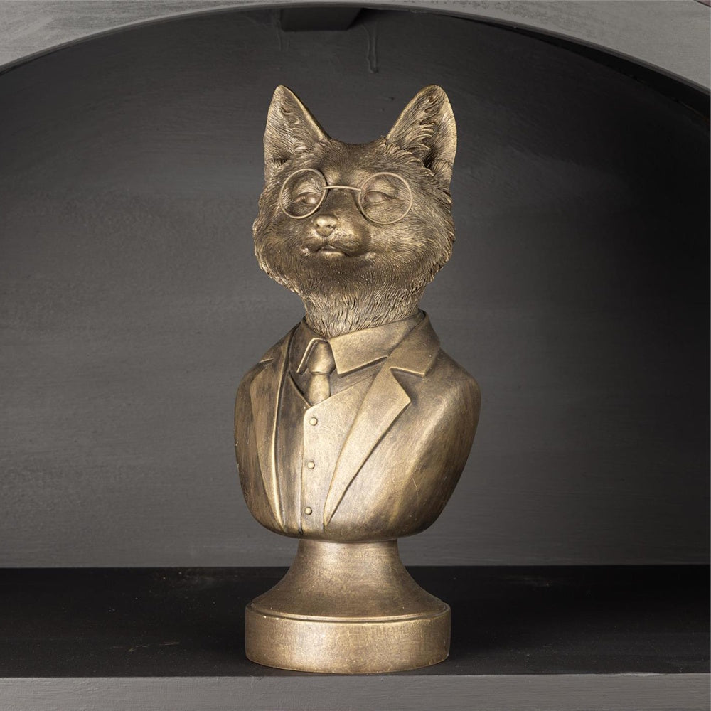 Bronze bust of a fox wearing round glasses, a suit, and tie, set against a dark background.
