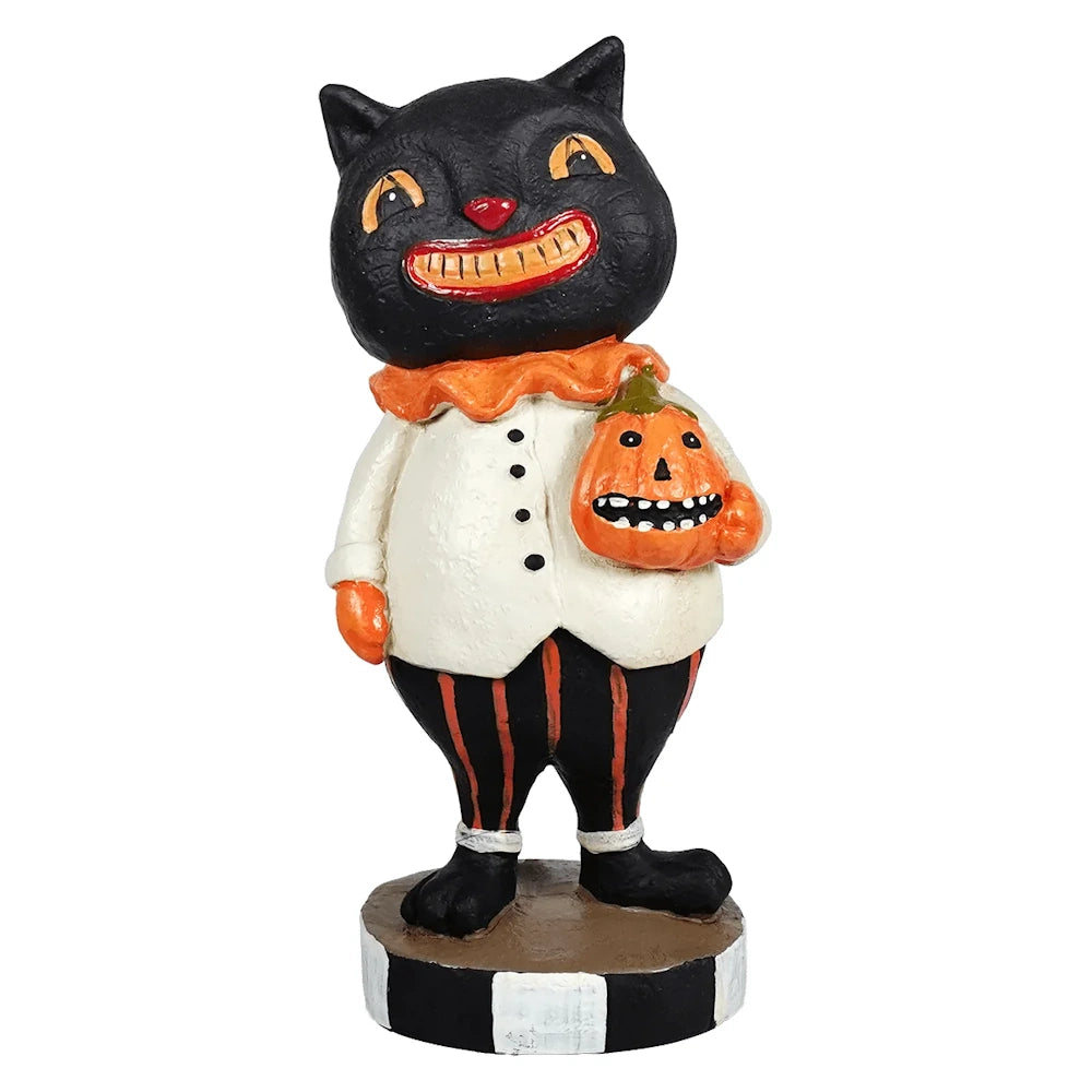 Vintage-style smiling black cat figurine wearing a white jacket and striped pants, holding a jack-o'-lantern.
