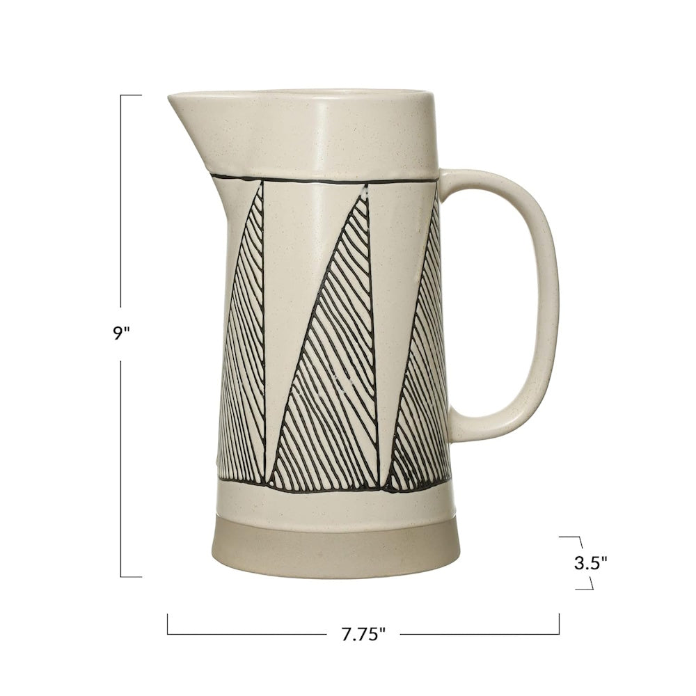 A cream stoneware pitcher with black geometric patterns, showing height, width, and depth dimensions.