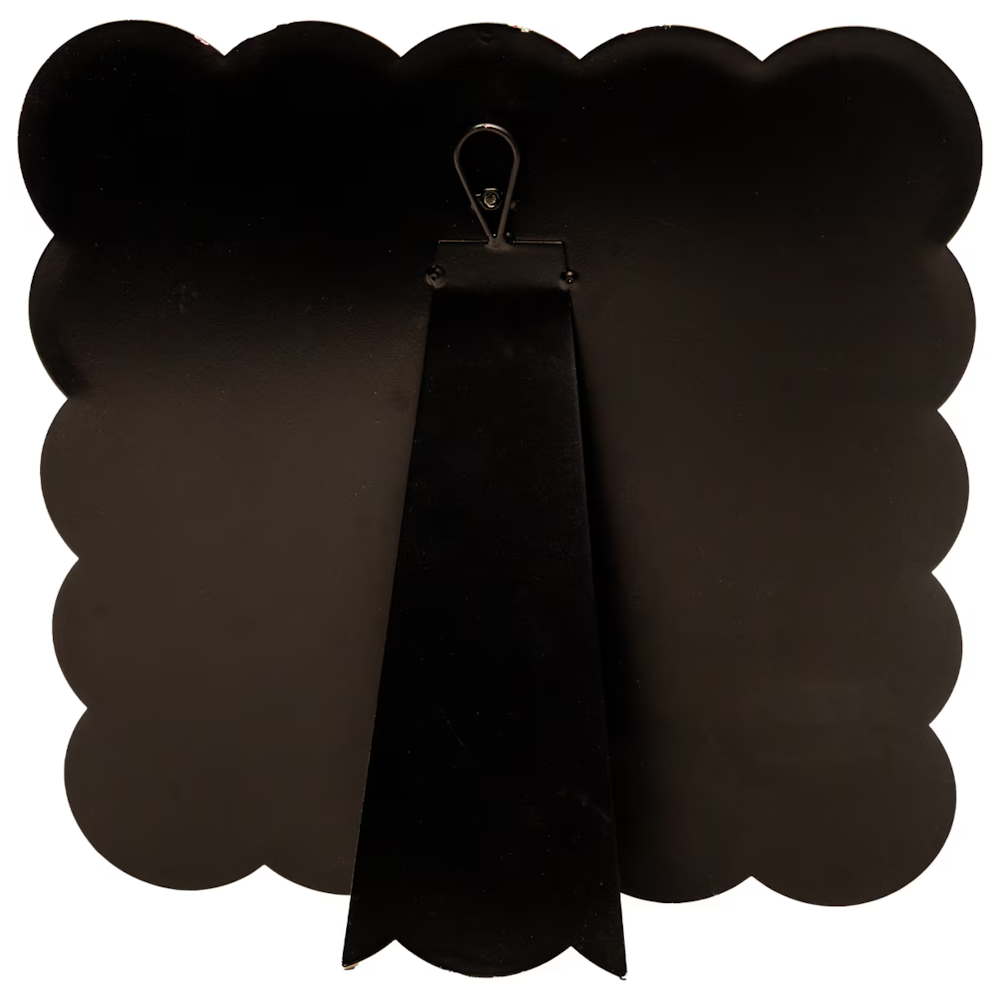 Back of black scalloped display board featuring a built-in easel stand and metal hanging loop for tabletop or wall decor.