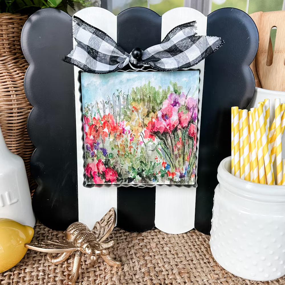 Floral garden watercolor art on a black and white striped scalloped display board with a buffalo check bow.
