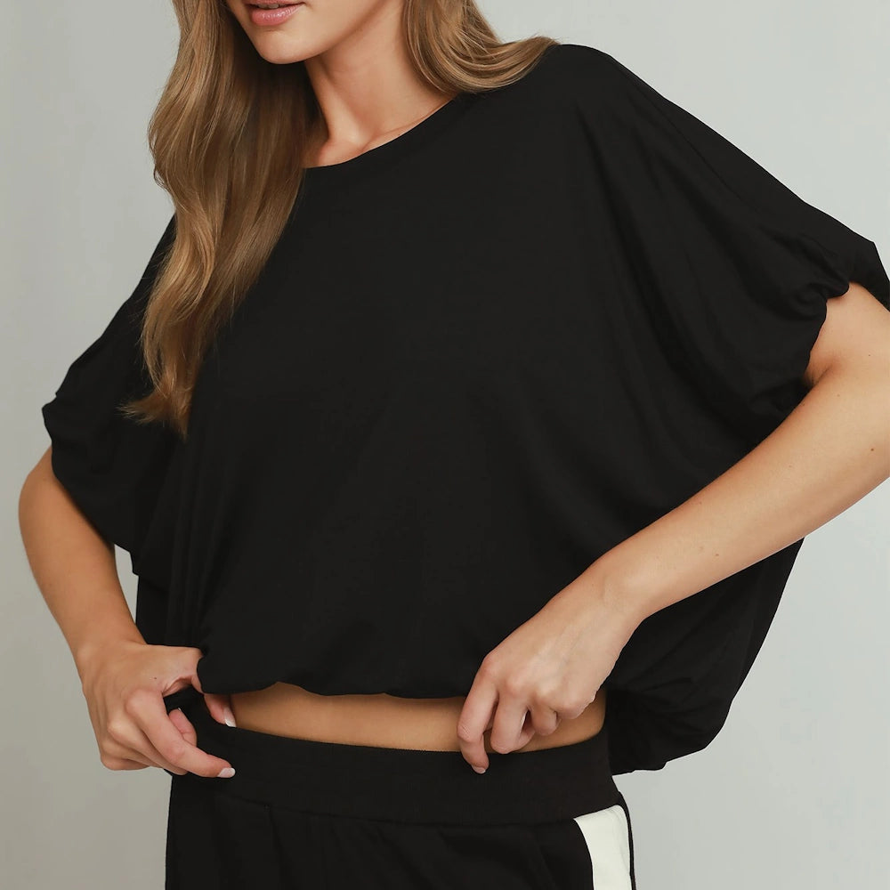 Black short-sleeve top featuring wide, draped bubble sleeves and a gathered bubble hem.