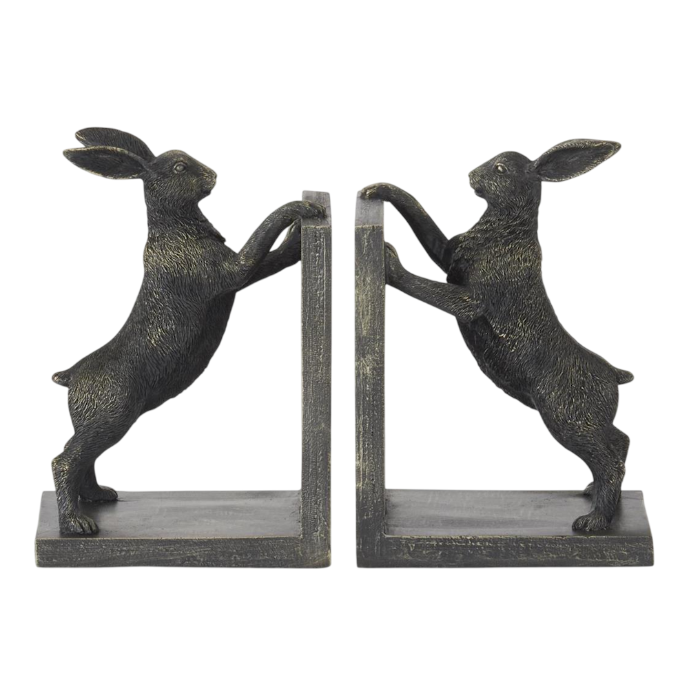 A pair of dark bronze bookends shaped like rabbits standing on their hind legs and pushing inward.