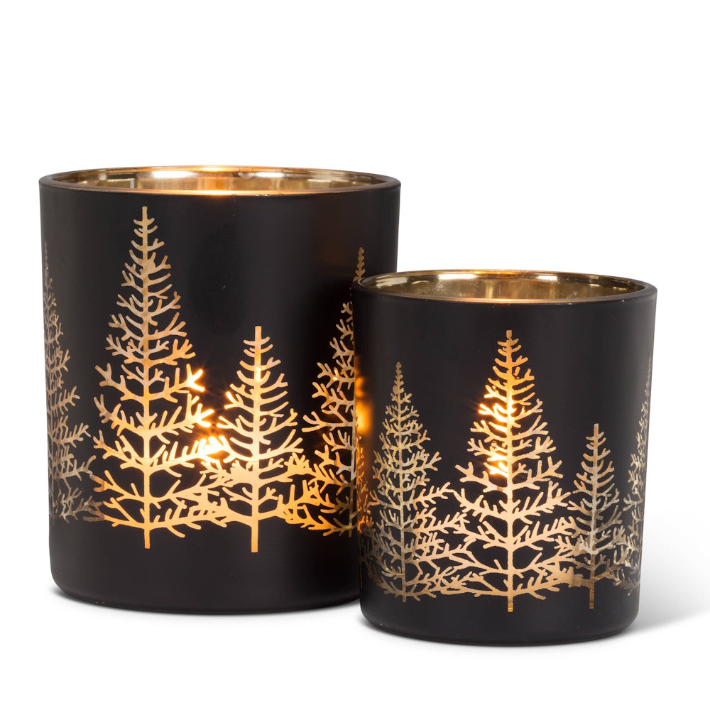 Two black glass tealight candle holders with metallic gold pine tree silhouettes.
