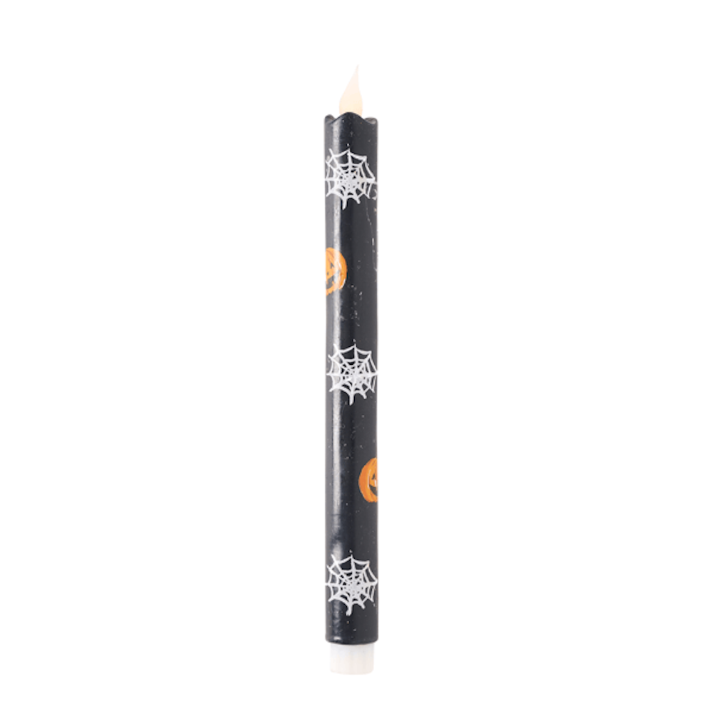 Black LED taper candle with spiderwebs and pumpkins for Halloween party decor.