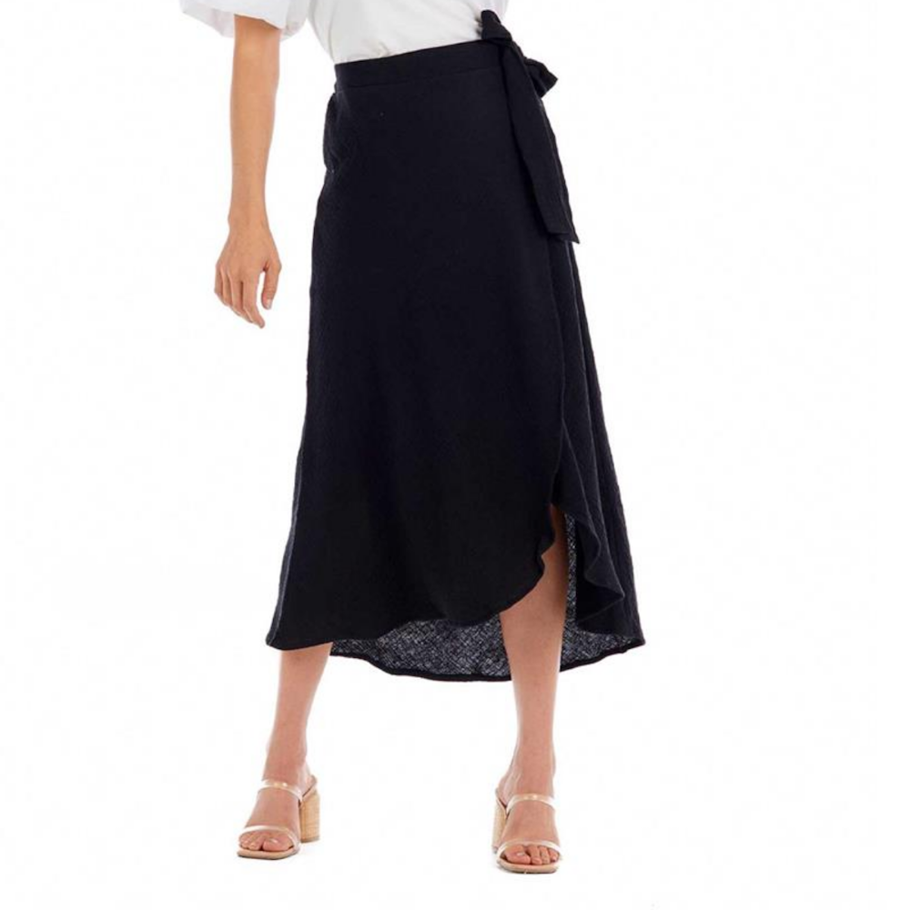 Black midi wrap skirt with a side waist tie, paired with a white top and heels.
