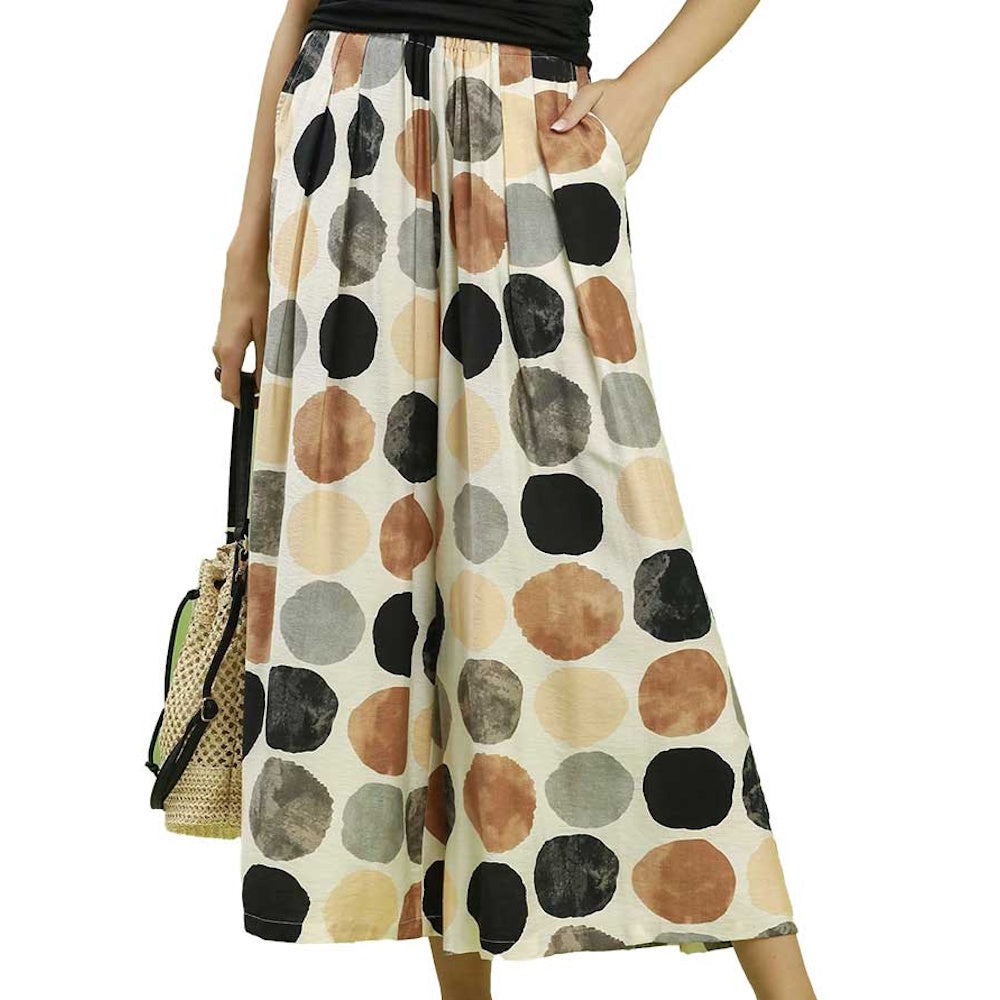 High-waisted wide-leg pants featuring a multicolor polka dot print in black, brown, and grey.