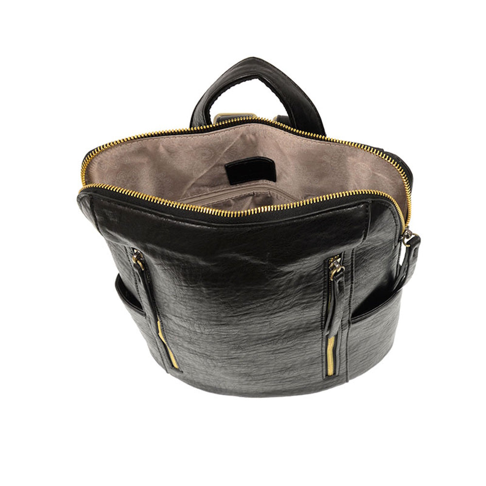 Open black double zipper backpack showing spacious tan interior, gold hardware, and side pockets on white background.