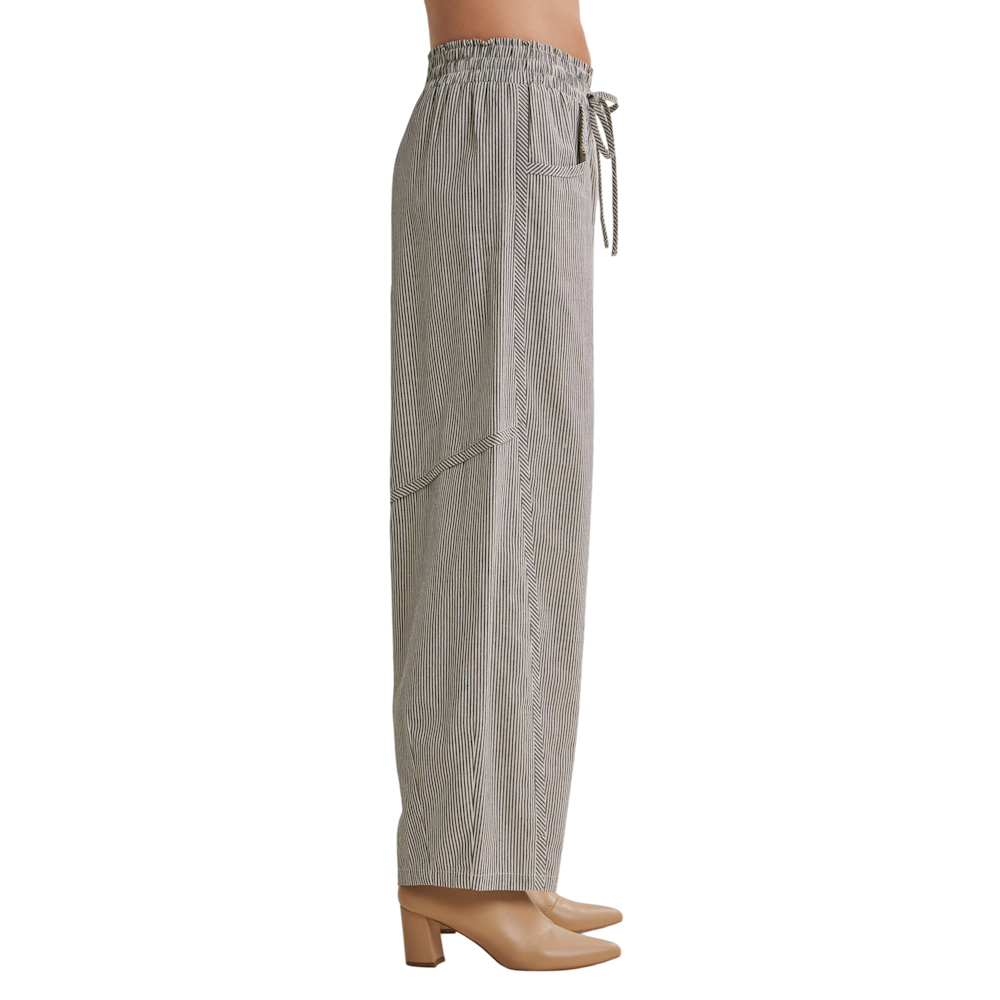 Side profile of wide-leg striped barrel pants with an elastic drawstring waist and tan heels.
