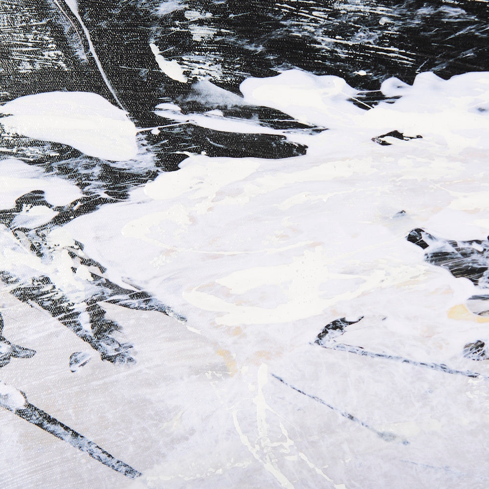 Close-up of thick white and black abstract paint strokes on canvas.