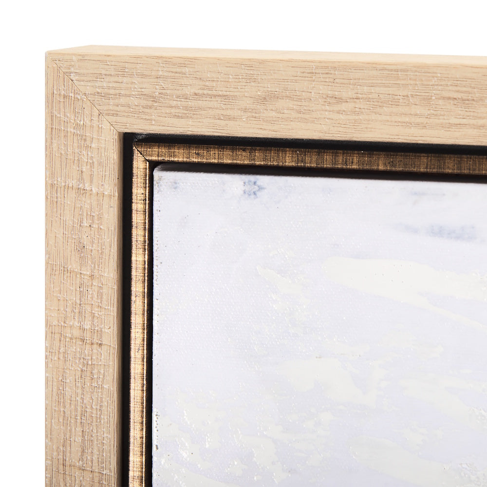 Close-up of the light wood frame corner and inner border of the canvas.