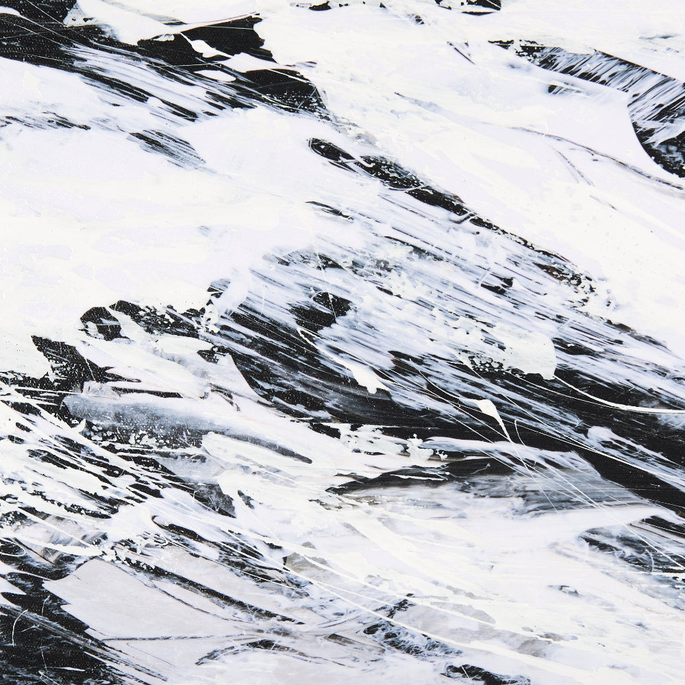 Close-up of thick, textured white and black paint strokes on a canvas.