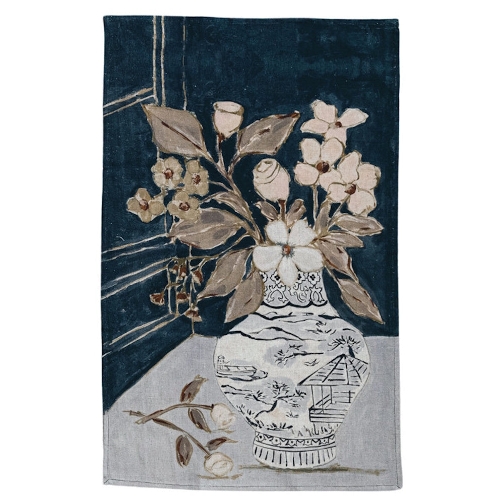 Painted tea towel featuring a white vase with flowers against a dark blue background.